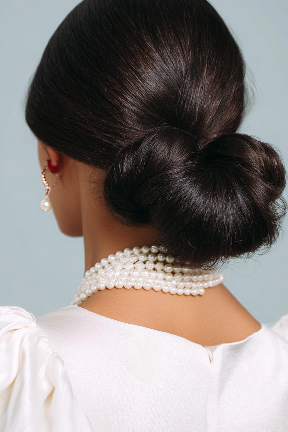 9. New Hairstyles 2026 Low Knot Bun with Center-Part Precision