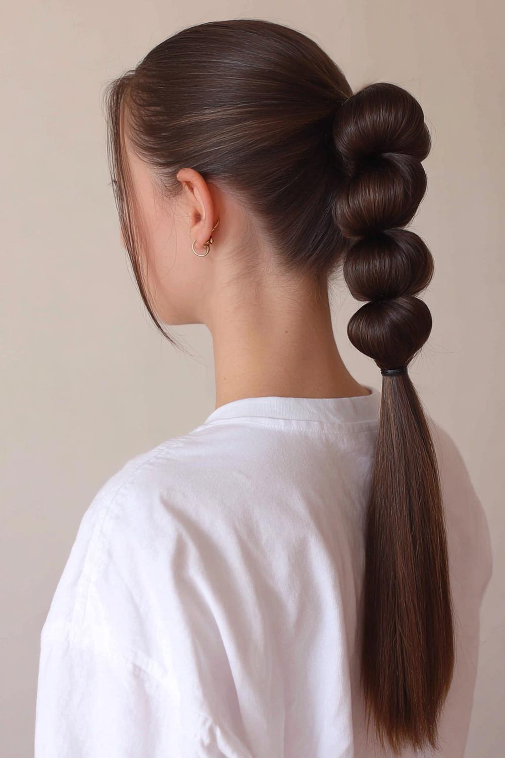 13. Popular Hairstyles 2026: Bubble Braid Ponytail With Clear Elastics and Smooth Sections