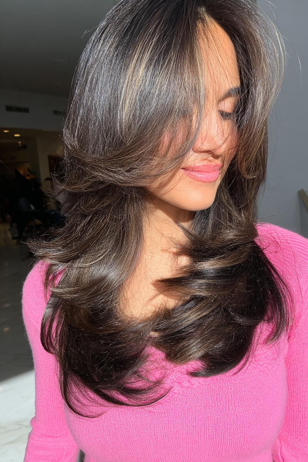 6. Popular Hairstyles 2026: Butterfly Layers With Bouncy Blowout and Long Swoop Bangs